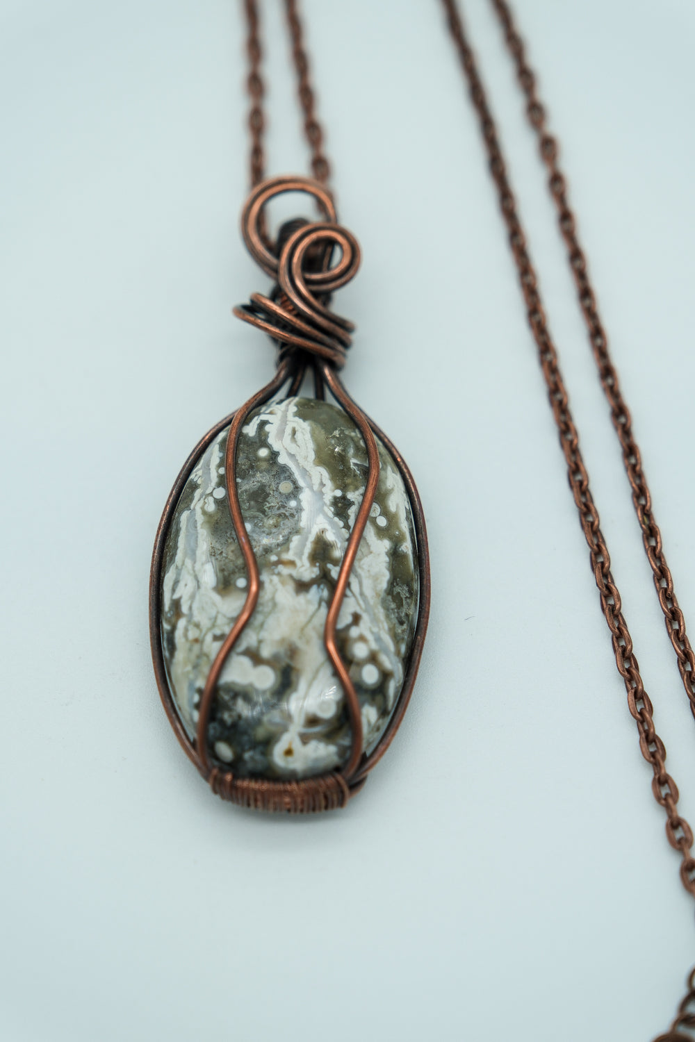 Necklace with a pendant featuring a natural stone design on a white background