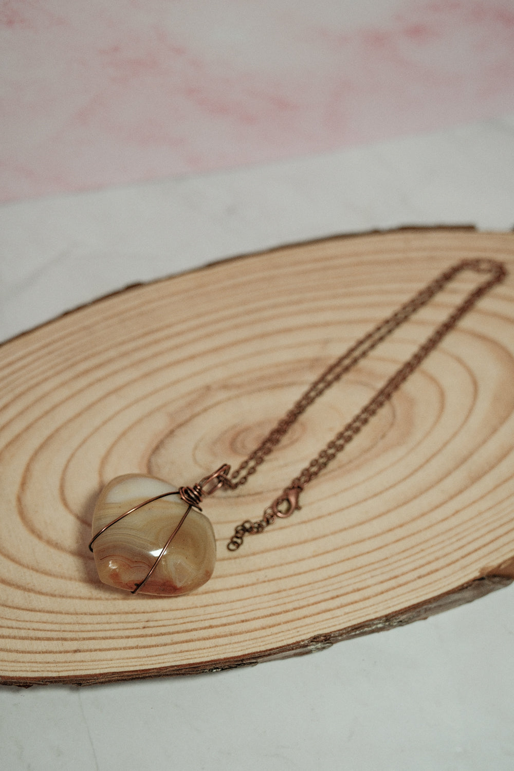 Necklace with a heart-shaped pendant on a wooden surface