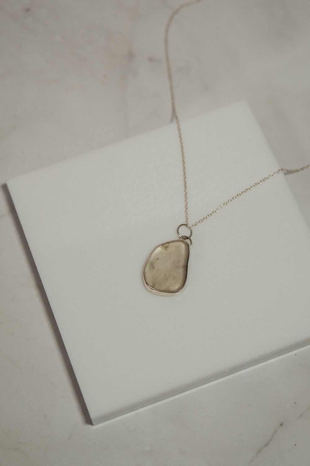 Necklace with a pendant on a white surface