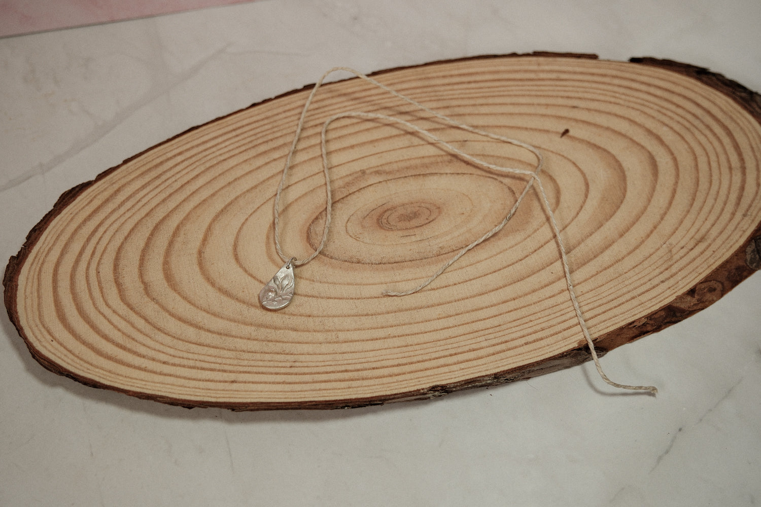 Necklace with a pendant on a wooden surface