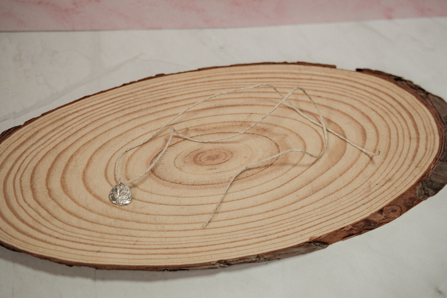 Necklace with a heart pendant on a wooden surface