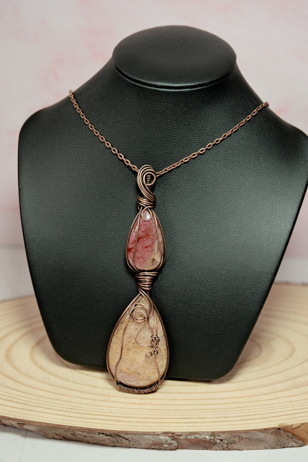 Necklace with a pendant on a black mannequin bust against a light background