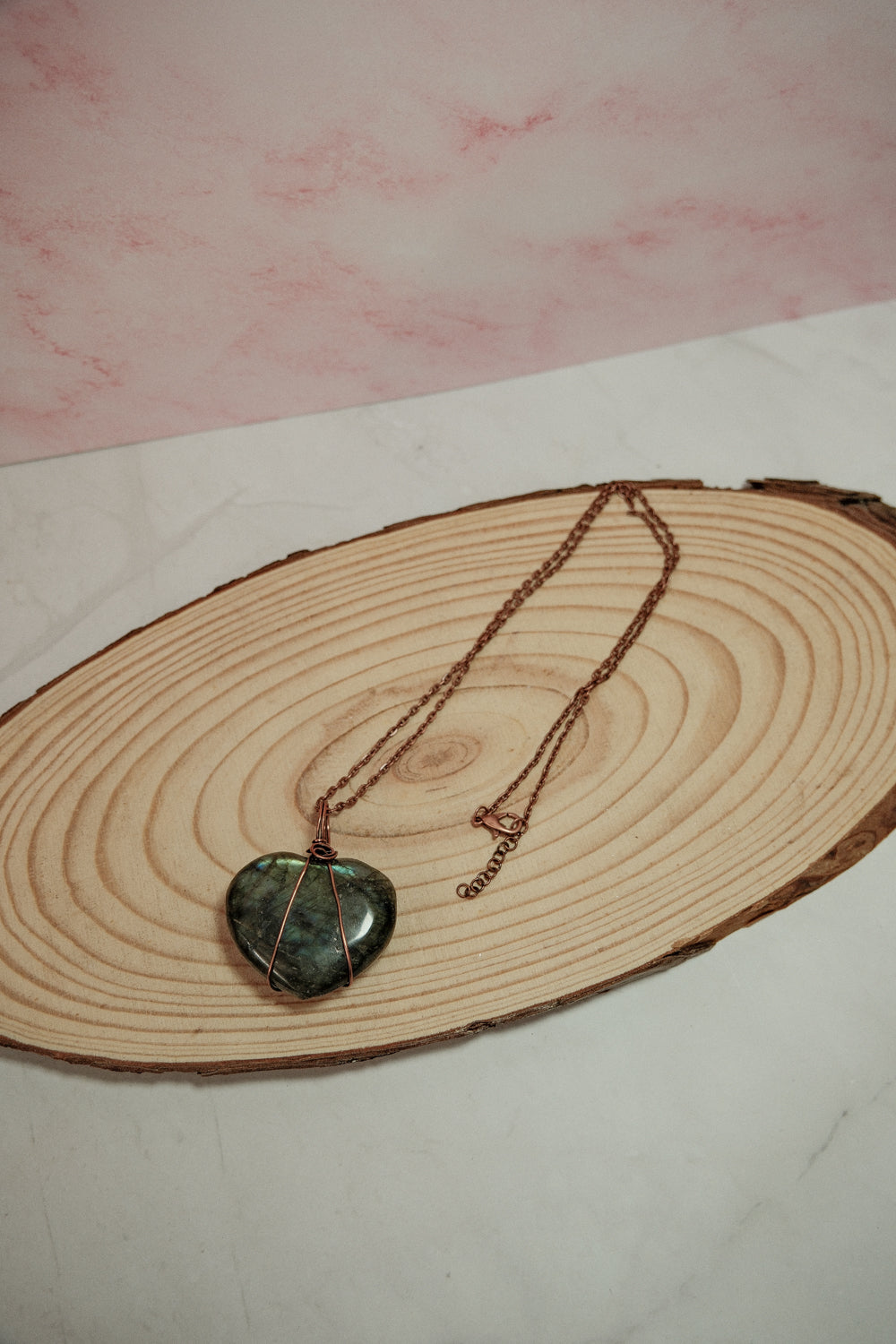 Necklace with a heart-shaped pendant on a wooden surface