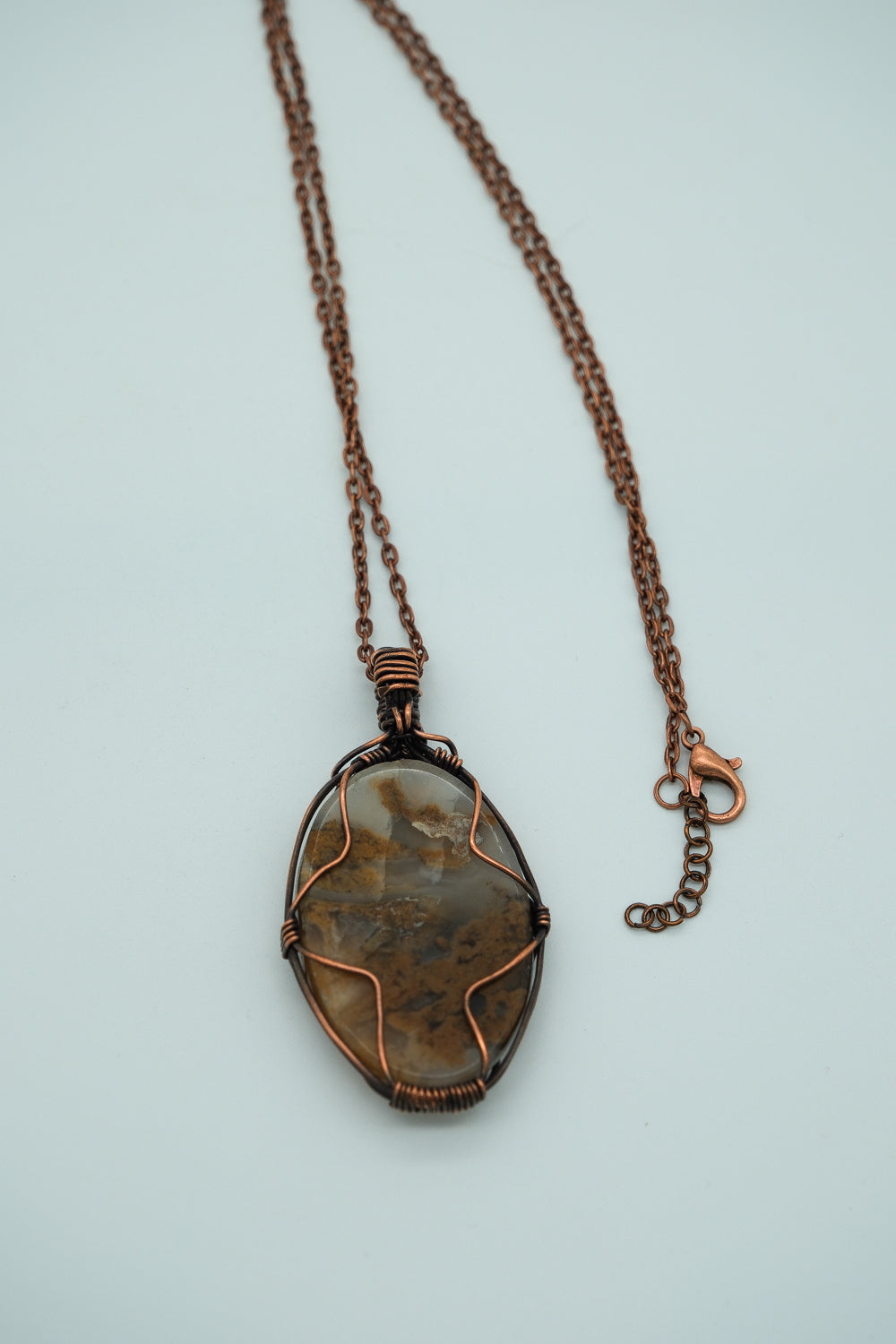 Necklace with a pendant on a light blue background