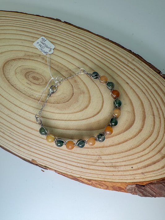 Beaded bracelet on a wooden surface with white tag.