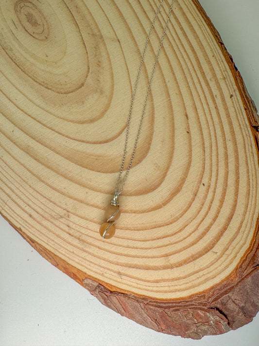 Necklace with a pendant on a wooden surface