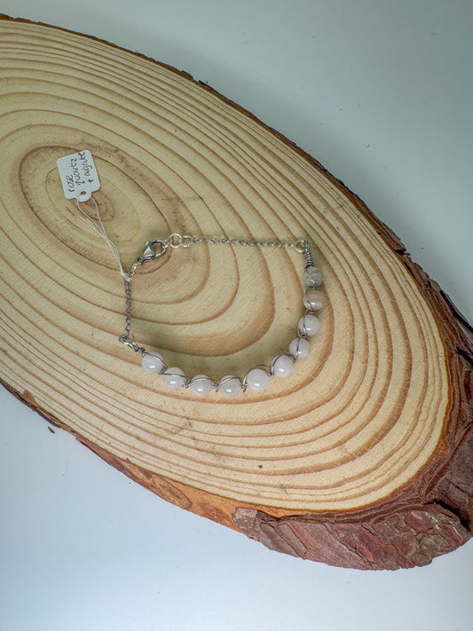 Rose quartz bracelet on a wooden surface