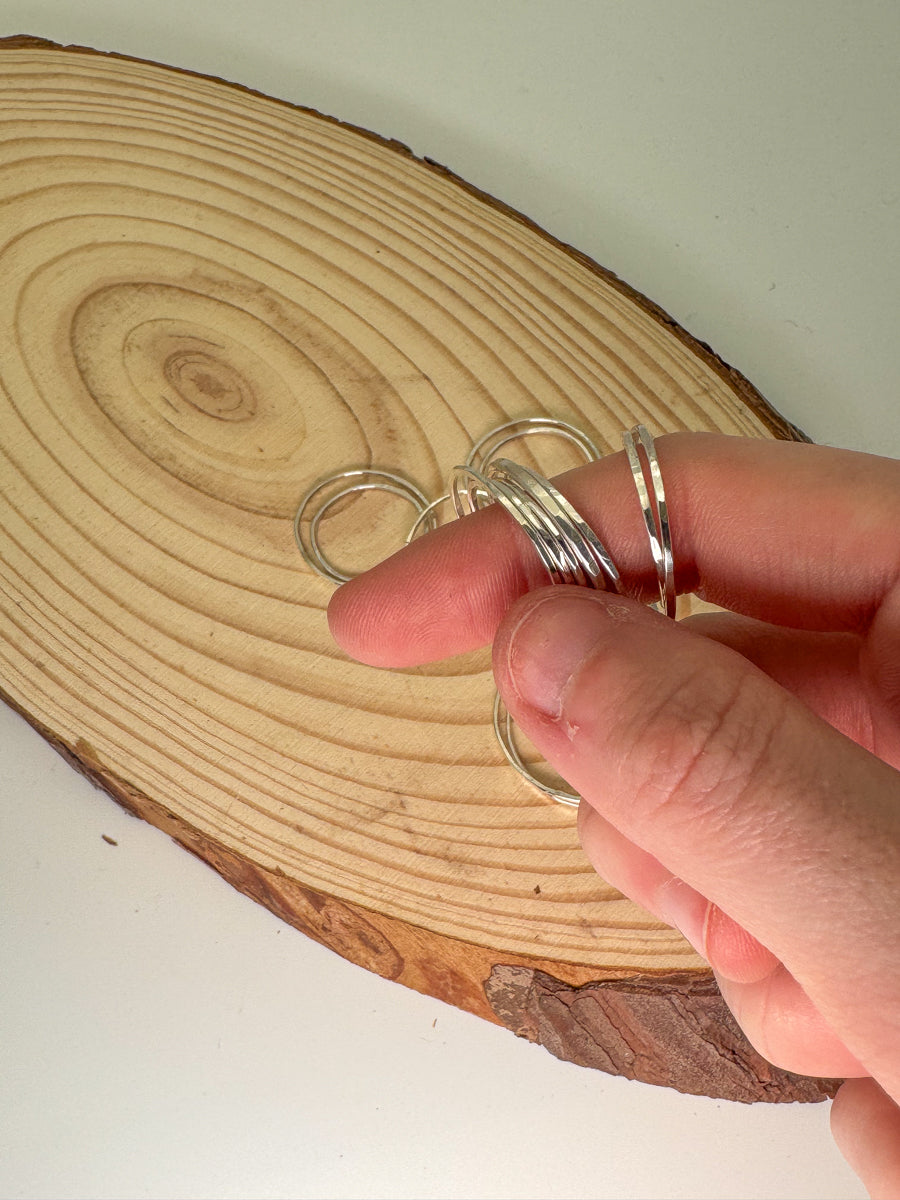 Sterling silver stacking rings on finger