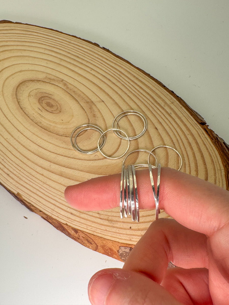 Sterling silver stacking rings on finger